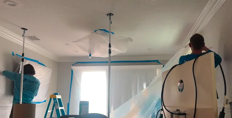 Mold remediation technician setting up HEPA containment on a New York City job site