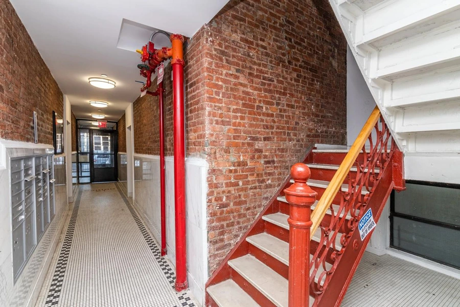Hallway of an older co-op building showing shared walls and plumbing risers